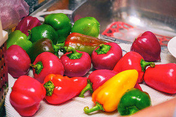 Bell peppers on a white towel in the kitchen