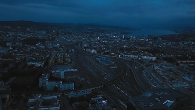 night aerial city view around skyscraper and train track