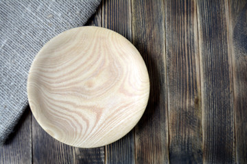 Empty wooden plate on the table Top view Kitchen decor Brown tones	