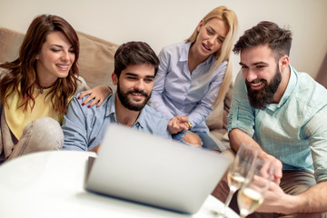 Fototapeta premium Group of friends sitting together in living room