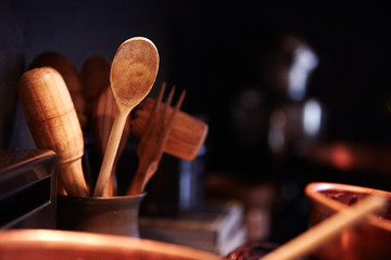 wooden kitchen tools in rustic container