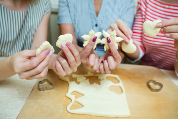 women in the kitchen preparing cookies from the dough