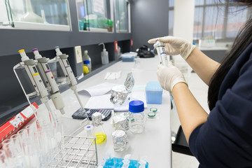 Fototapeta premium Asian scientist working in the lab,Experiment for customer,Using the formula, the physics and chemistry to calculate the value of the experiment,Thailand people