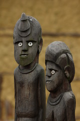 A traditional wooden African tribal statues. They look quite funny with their white eyes and teeth. 