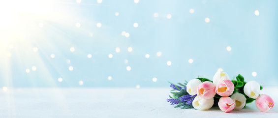 bouquet of tulips with bokeh lights on a blue background.