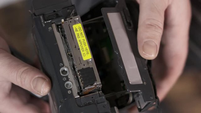 Taking out mini DV cassette tape from the camcorder