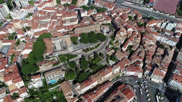 Aerial helicopter view of Le Suquet the old town located in Cannes France the fortified tower and Chapel of saint Anne house the Museum de la Castre a distinctive building of Russian Orthodox church