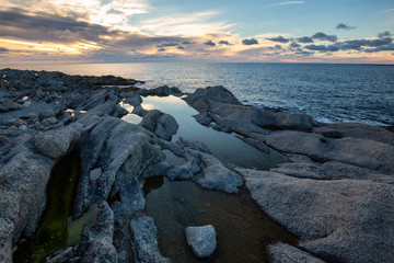 Beautiful rocky Atlantic Ocean Coast during a vibrant sunset. Taken at Cow Head, Newfoundland, Canada.
