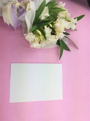 Bouquet of white flowers on pink background.