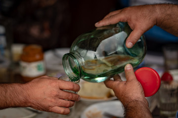 Bottling of moonshine from a large jar