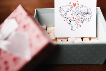 Card with kissing children in the box with marshmallow