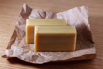 two pieces of brown natural soap on craft paper