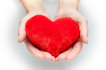 Female hands giving red heart