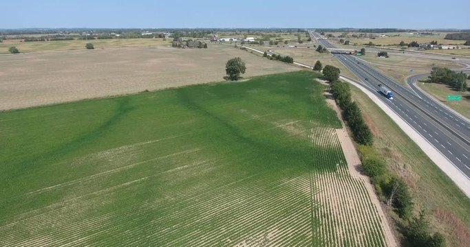 Highway Drone Shot Moving Towards Access Ramp With Farmfields