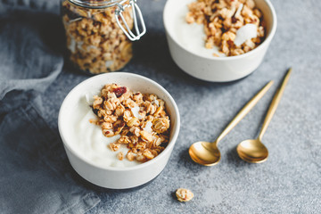 Breakfast bowl with organic granola, nuts, coconut chips and greek yoghurt.