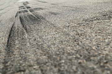 The rubber tracks from the rallye cars left on the tarmac in the hairpin. 