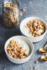 Obraz na płótnie Canvas Breakfast bowl with organic granola, nuts, coconut chips and greek yoghurt.