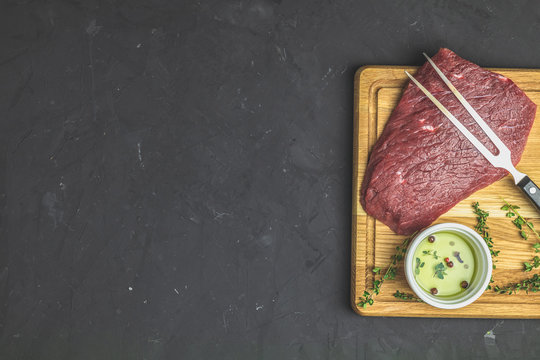 Fresh raw meat beef steak on wooden cutting board