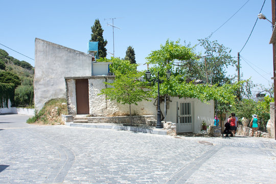 house on a narrow street in the village of Krasi in Crete