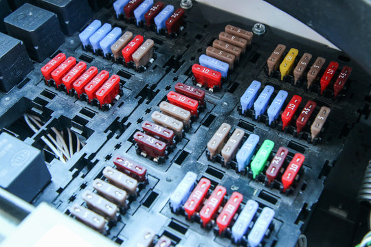 The detail of the fuse box in the car´s engine room. Many fuses with different values of current. 