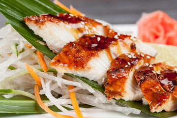 Japanese national popular cuisine. Sushi, rice and fish. Tasty, beautifully served food in a restaurant, cafe, with elements of the original design.