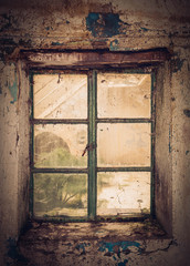Fototapeta na wymiar An old window inside an abandoned house.