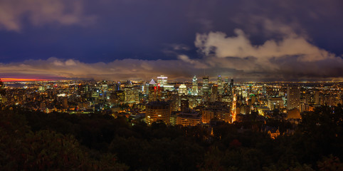 Aerial panoramic view of a beautiful modern downtown city during a striking cloudy sunrise. Taken...