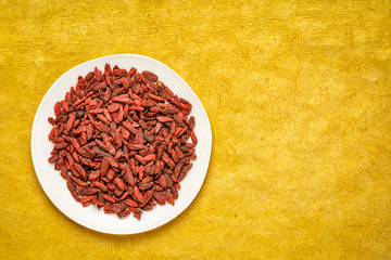 dried goji berries on a white plate