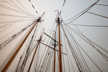 Fototapeta premium Port Hardy, Vancouver Island, BC, Canada - August 20, 2018: Wooden sailboat parked at a marina during a foggy summer day.