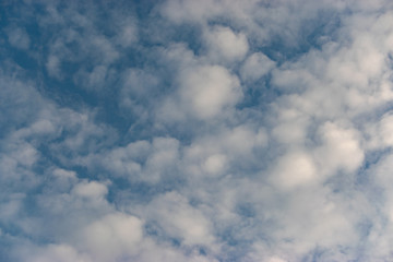 Winter clouds on a light blue sky. Background of clouds and the sky