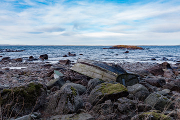 rowing boat upsidedown on a rocky beach