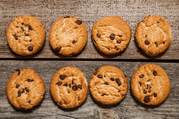Chocolate chip cookies on wooden background. Sweet biscuits. Homemade pastry