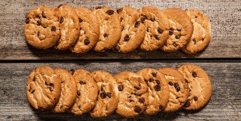 Chocolate chip cookies on wooden background. Sweet biscuits. Homemade pastry