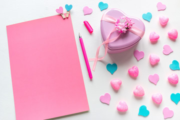 a blank page with space for text and a heart-shaped gift for Valentine's Day