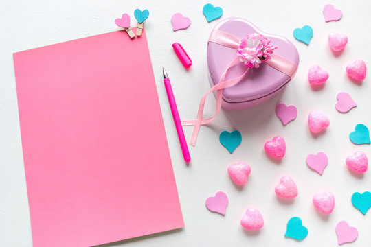 a blank page with space for text and a heart-shaped gift for Valentine's Day