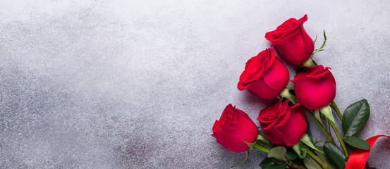 Red rose flowers bouquet on stone background Valentine's day greeting card Copy space Flat lay Horizontal banner - 246475384