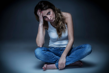 Upset woman cutting her with shears long smooth hair. Hair care concept.