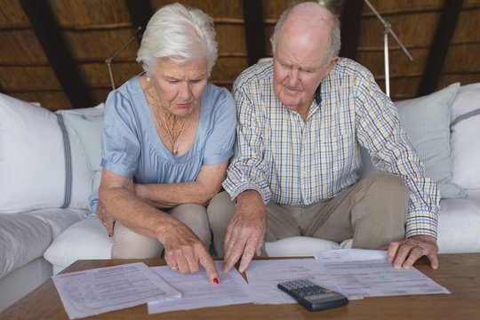 Senior Couple Discussing Over Medical Bills In Living Room