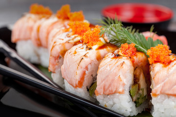 Japanese national popular cuisine. Sushi, rice and fish. Tasty, beautifully served food in a restaurant, cafe, with elements of the original design.