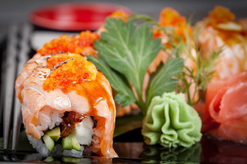 Japanese national popular cuisine. Sushi, rice and fish. Tasty, beautifully served food in a restaurant, cafe, with elements of the original design.