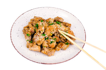 Plate with slices of chicken in batter with sesame seeds