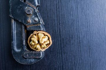 Fresh walnuts on a wooden table with nutcracker.