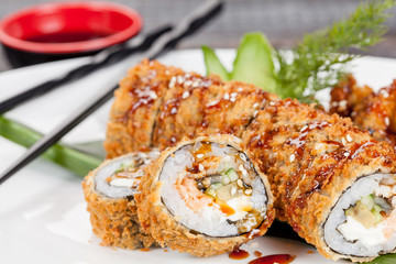 Japanese national popular cuisine. Sushi, rice and fish. Tasty, beautifully served food in a restaurant, cafe, with elements of the original design.