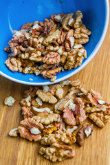 Close up of healthy brown walnuts scattered on the wooden table