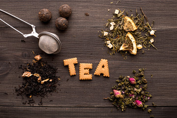Several views of tea and a cookie inscription on a wooden background