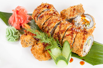 Japanese national popular cuisine. Sushi, rice and fish. Tasty, beautifully served food in a restaurant, cafe, with elements of the original design.