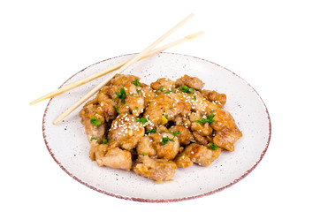 Plate with slices of chicken in batter with sesame seeds