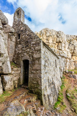 Fototapeta na wymiar St Govan´s Chapel at Pembrokeshire coast an awe and small religious temple on the west coast of UK at Wales. Located inside the cliffs over the Atlantic Ocean make it a wonderful and idyllic scenery