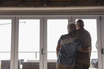 Senior couple standing together at home