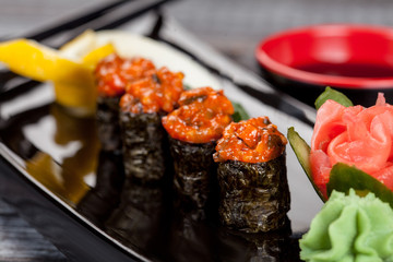 Japanese national popular cuisine. Sushi, rice and fish. Tasty, beautifully served food in a restaurant, cafe, with elements of the original design.